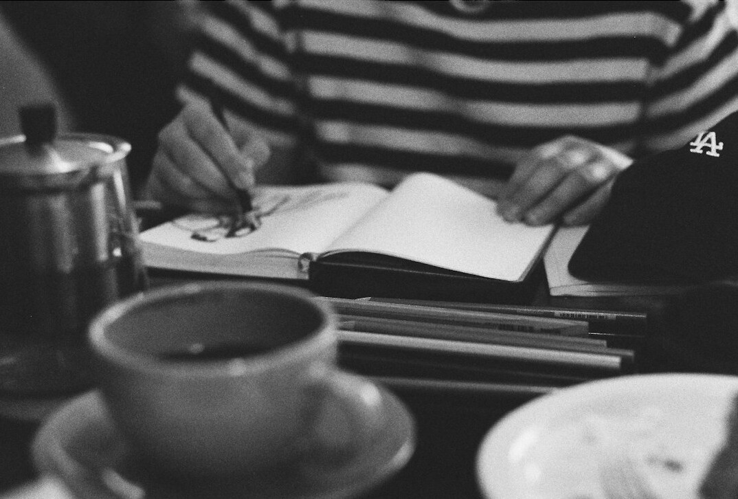 person taking notes in cafe