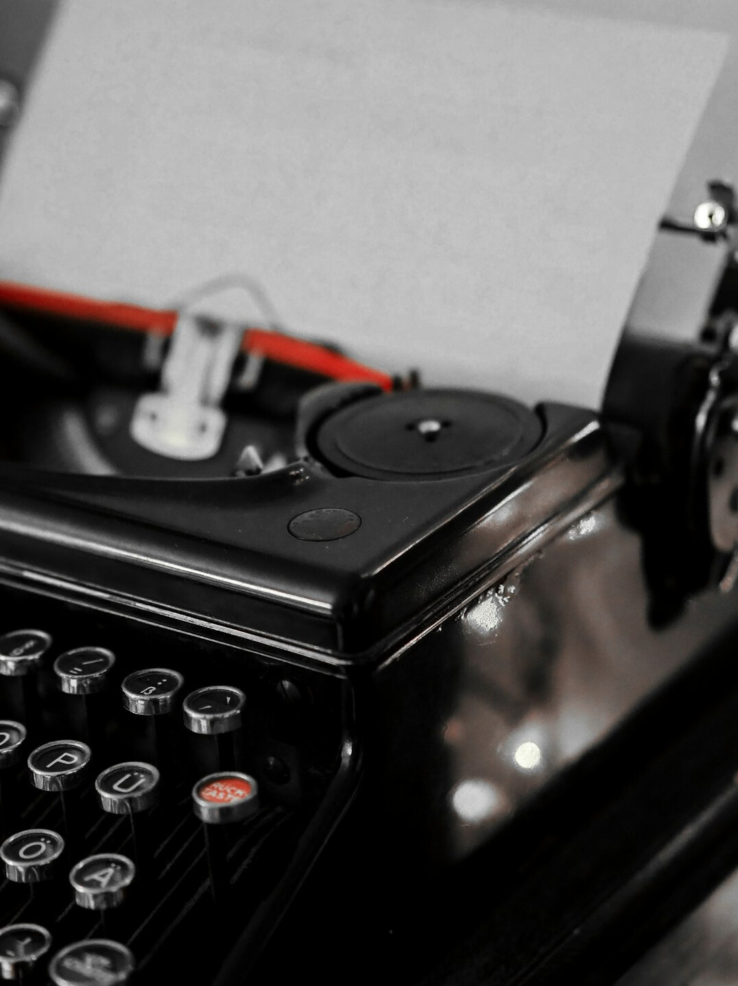 Close-up of a vintage typewriter with a sheet of paper